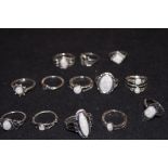 A collection of 13 white metal rings