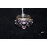 Silver ring set with purple stones