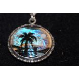 Silver necklace and pendant depicting palm tree wi