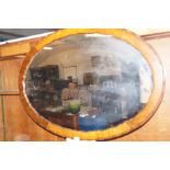 A large Edwardian oval wall mirror