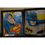 Framed superman and batman prints in the style of