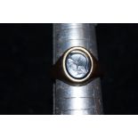 9ct gold ring set with black hard stone, carved pi