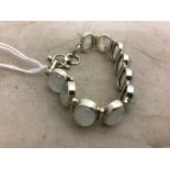 A silver and oval moonstone bracelet