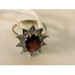 A 9ct garnet star ring