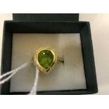 An 18ct pendaluque cut peridot and diamond dress ring
