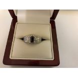 An 18ct diamond set ring with emerald cut diamond