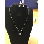 A platinum demi-parure set of diamond set necklace, ring and earrings, set in floral design,