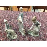 Three Lladro figurines: a girl picking flowers,