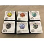 Six assorted glass paperweights