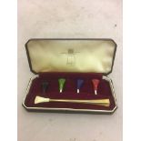 A gold Dunhill cigarette holder in fitted case with various coloured mouth pieces