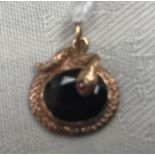 A 9ct smokey quartz pendant surrounded by a snake