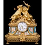 A 19th Century French Gilt Mantel Clock: With child feeding a goat above the dial,