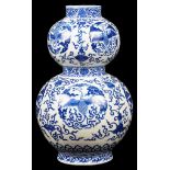 A Chinese blue and white double gourd vase: 19th century, decorated with phoenixes in medallions,