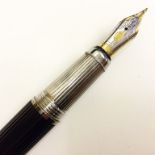 A Cartier Fountain Pen: The black case with fine ribbing,