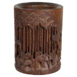 A Chinese bamboo brush pot: 19th century, with low relief figural scenes amongst trees and foliage,