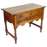 An 18th Century Oak Lowboy: With a one over two drawer arrangement,