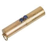 A Gold and Sapphire Set Pill Box: The twist action opening to release pills set with two cabochon