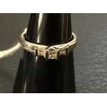 A princess-cut 3 stone diamond ring 0.