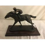 A resin figure of a horse and jockey