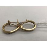 A pair of 18k yellow gold oval hoop earrings with seven each pavee-set brilliant-cut diamonds (0.