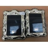 A pair of ornate HM silver photograph frames