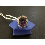 A modern repro dress ring comprising one central amethyst (est 4.