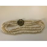 A three-strand pearl necklace with 9ct turquoise set clasp