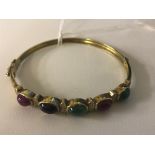 A 14k cabochon set hinged bangle