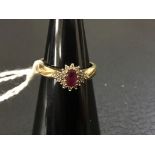 A ruby and diamond cluster ring with central ruby (est 0.