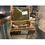 An onyx box containing silver spoons