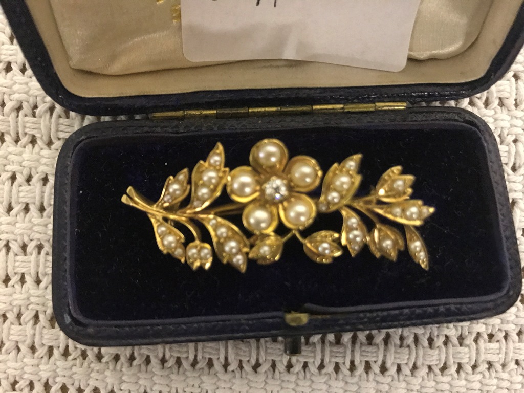 A cased pearl and diamond brooch