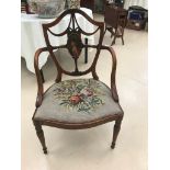 A 19th century hepplewhite design chair the central shield cartouche handpainted with a lady