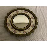 A ceramic and gilt wall mirror