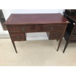 An Edwardian mahogany leather topped writing desk;