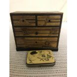 A miniature chest of drawers;