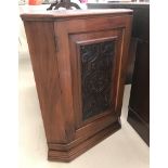 A mahogany corner cabinet