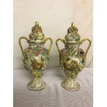 A pair of floral vases with painted cottage scenes,