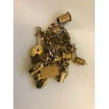 A 9ct gold charm bracelet with charms to inc 1914 half sovereign
