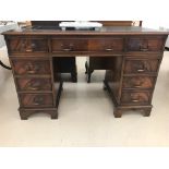 A mahogany leather-topped twin pedestal desk