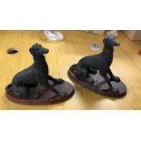 A pair of resin figures of greyhounds on a faux marble base