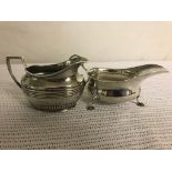 A HM silver gravy boat together with a HM silver cream jug