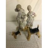 A pair of bisque figures;