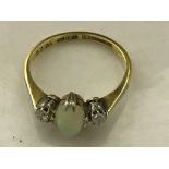 An 18ct and platinum diamond and cabochon opal ring