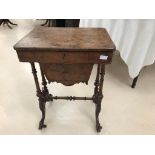 A 19th century walnut sewing table