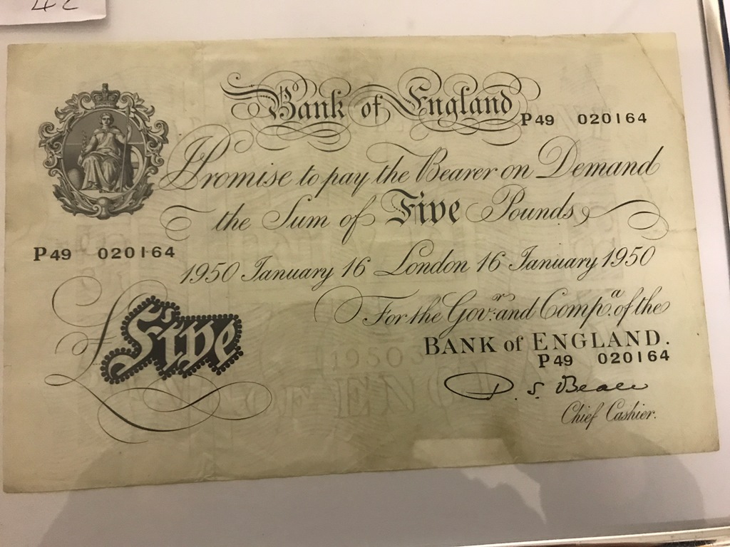 A white £5 note dated 16th January 1950 (framed and glazed)