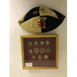 A framed group of miniature football medals;