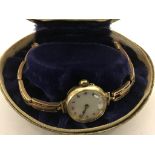 A 9ct gold ladies watch on a 9ct gold strap