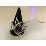 A silver abstract amethyst dress ring