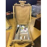 An artist's travelling easel and paints in carry case