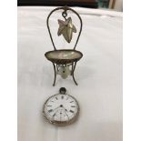 A pocket watch on a stand in the form of a chair